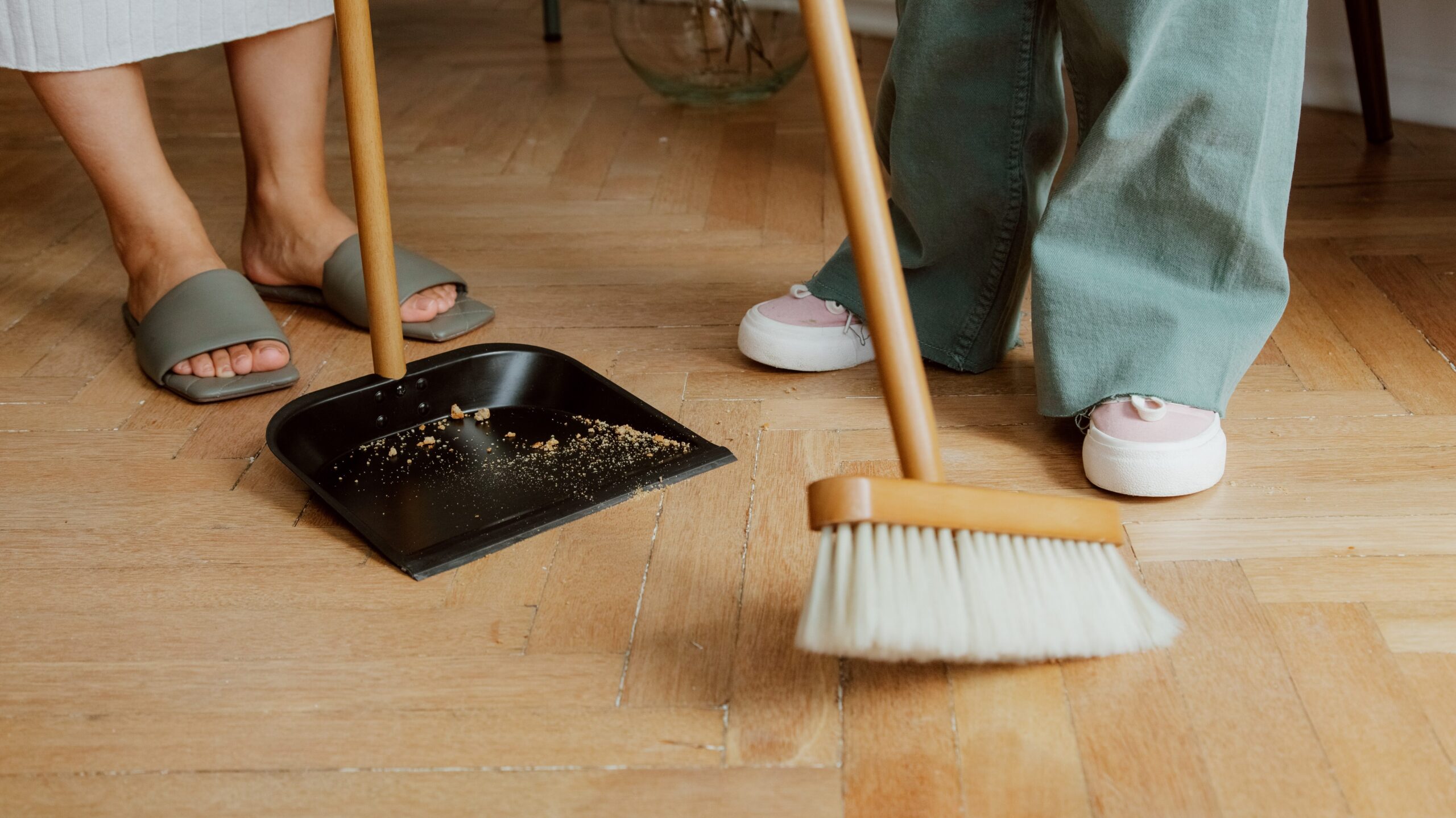 cleaning up floor by using wisp broom